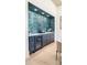 Custom wet bar in a dining area with stone backsplash, ample cabinetry, and a beverage cooler at 115 Nova Ln, Roswell, GA 30075