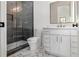 Elegant bathroom boasts a glass-enclosed shower, white vanity, and marble flooring at 115 Nova Ln, Roswell, GA 30075