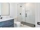 Bathroom featuring a glass shower door, black fixtures, and marble countertops at 115 Nova Ln, Roswell, GA 30075