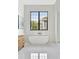Bright bathroom with soaking tub and large window with a view of the property exterior at 115 Nova Ln, Roswell, GA 30075