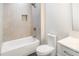 Bathroom featuring a bathtub, vanity, gray tile, and plenty of natural light at 115 Nova Ln, Roswell, GA 30075