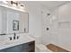 This bathroom features modern design with a glass shower, marble countertops, and dark-stained cabinets at 115 Nova Ln, Roswell, GA 30075