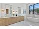 Bright bathroom with marble countertops, soaking tub, and large window with exterior views at 115 Nova Ln, Roswell, GA 30075