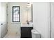 Modern bathroom with a decorative tile accent wall and a vanity with dark hardware at 115 Nova Ln, Roswell, GA 30075