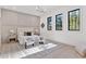 Bright bedroom with panel wall, seating area, and black trim windows at 115 Nova Ln, Roswell, GA 30075