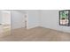 Bedroom featuring hardwood floors, closet, and window with black frame providing lots of light at 115 Nova Ln, Roswell, GA 30075