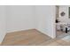 Empty room shows off the light-colored wood flooring with a view into an adjacent staged bedroom at 115 Nova Ln, Roswell, GA 30075
