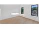 Bright bedroom features light hardwood floors, white walls, and two windows at 115 Nova Ln, Roswell, GA 30075