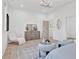 Bright bedroom with modern chandelier, sitting area, and neutral decor at 115 Nova Ln, Roswell, GA 30075