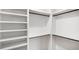 Walk-in closet featuring adjustable shelves and rod for ample storage space at 115 Nova Ln, Roswell, GA 30075