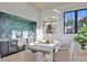 Bright dining room with bar and wine fridge, stylish lighting, and black framed windows at 115 Nova Ln, Roswell, GA 30075