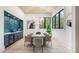 Dining area with a large table, stylish chairs, a custom bar area and plenty of natural light at 115 Nova Ln, Roswell, GA 30075