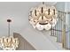 Stylish foyer featuring contemporary chandeliers, a staircase, and neutral color palette at 115 Nova Ln, Roswell, GA 30075