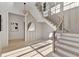 Elegant foyer featuring a staircase, modern chandelier, and neutral color palette at 115 Nova Ln, Roswell, GA 30075