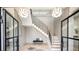 Elegant foyer with hardwood floors, a staircase with black iron railing, and designer lighting at 115 Nova Ln, Roswell, GA 30075