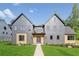 Beautiful modern home with a gray exterior, manicured lawn and symmetrical design on a sunny day at 115 Nova Ln, Roswell, GA 30075