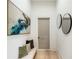 Elegant hallway featuring decorative wall art, neutral-toned decor, and hardwood floors at 115 Nova Ln, Roswell, GA 30075