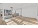 Upstairs hallway boasts hardwood floors, black railing staircase and modern chandelier lighting at 115 Nova Ln, Roswell, GA 30075