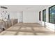 Bright hallway featuring hardwood floors, black framed windows and modern chandelier lighting at 115 Nova Ln, Roswell, GA 30075