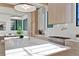 Kitchen island with marble countertop, stainless steel appliances, white backsplash, and custom cabinetry at 115 Nova Ln, Roswell, GA 30075