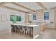 Open concept kitchen with large island, breakfast bar, and natural wood beams and cabinets at 115 Nova Ln, Roswell, GA 30075