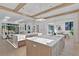 Open concept kitchen with a central island, white countertops, views of the living and dining area, and ample natural light at 115 Nova Ln, Roswell, GA 30075