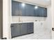 Laundry room featuring modern cabinets, countertop space, and stylish fixtures at 115 Nova Ln, Roswell, GA 30075