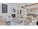 Bright living room with fireplace, modern lighting, and open floor plan to the kitchen at 115 Nova Ln, Roswell, GA 30075