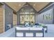 Covered outdoor patio with fireplace, comfortable seating, and backyard views at 115 Nova Ln, Roswell, GA 30075