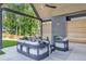 Inviting covered patio with outdoor seating and cozy fireplace, perfect for entertaining at 115 Nova Ln, Roswell, GA 30075