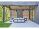 Relax on the backyard patio with comfortable seating, an outdoor fireplace, and a ceiling fan for warm days at 115 Nova Ln, Roswell, GA 30075