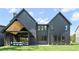 Modern home features a large backyard, covered patio, and sleek exterior design at 115 Nova Ln, Roswell, GA 30075