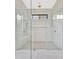 Elegant walk-in shower features dual shower heads, seating, and glass doors at 115 Nova Ln, Roswell, GA 30075
