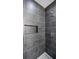 Modern shower with gray tiling, a built-in niche, and sleek fixtures at 115 Nova Ln, Roswell, GA 30075