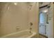 This bathroom features a white tiled shower-tub combo and opens to the vanity with storage at 177 Fairview Dr, Fairburn, GA 30213