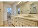 Well-lit bathroom features a dual sink vanity, large mirror, and closet at 177 Fairview Dr, Fairburn, GA 30213