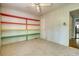 Bright bedroom with shelves, neutral carpet and view to another room through open doorway at 177 Fairview Dr, Fairburn, GA 30213