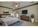 Staged bedroom with bed, dresser, TV, and view of the outside at 177 Fairview Dr, Fairburn, GA 30213