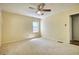 Neutral carpeted bedroom with ceiling fan and natural light through the window at 177 Fairview Dr, Fairburn, GA 30213