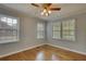 Bright bedroom with hardwood floors, neutral paint, and natural light from two windows at 177 Fairview Dr, Fairburn, GA 30213