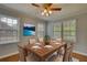 Formal dining room with wood table, seating for six and an elegant ceiling fan at 177 Fairview Dr, Fairburn, GA 30213