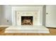 Close up of the fireplace featuring hardwood floors, decorative tiles, and a clean design at 177 Fairview Dr, Fairburn, GA 30213