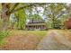 Charming brick home featuring a welcoming front porch, beautiful landscaping, and an inviting facade at 177 Fairview Dr, Fairburn, GA 30213