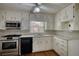 Updated kitchen featuring white cabinets, marble countertops and stainless steel appliances at 177 Fairview Dr, Fairburn, GA 30213
