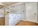 Kitchen counter with white cabinets and drawers, with view to the hall and back at 177 Fairview Dr, Fairburn, GA 30213