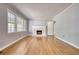 Open living room featuring a fireplace, hardwood floors, and lots of natural light at 177 Fairview Dr, Fairburn, GA 30213