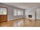 Open living room featuring a fireplace, hardwood floors, and lots of natural light at 177 Fairview Dr, Fairburn, GA 30213