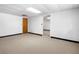 Finished basement area with neutral carpeting and painted walls is ready to be used as an office or workspace at 4927 Bedell Ne Rd, Roswell, GA 30075