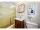 Cozy bathroom with a toilet, sink with vanity, medicine cabinet, and shower with sliding glass door at 4927 Bedell Ne Rd, Roswell, GA 30075