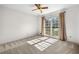 Bedroom with a ceiling fan and large window providing natural light at 4927 Bedell Ne Rd, Roswell, GA 30075